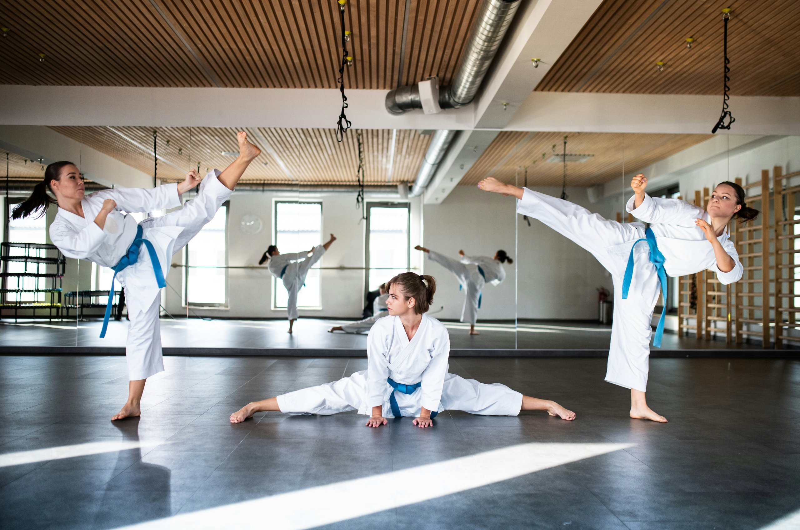 3 girls practicing at a martial arts dojo
