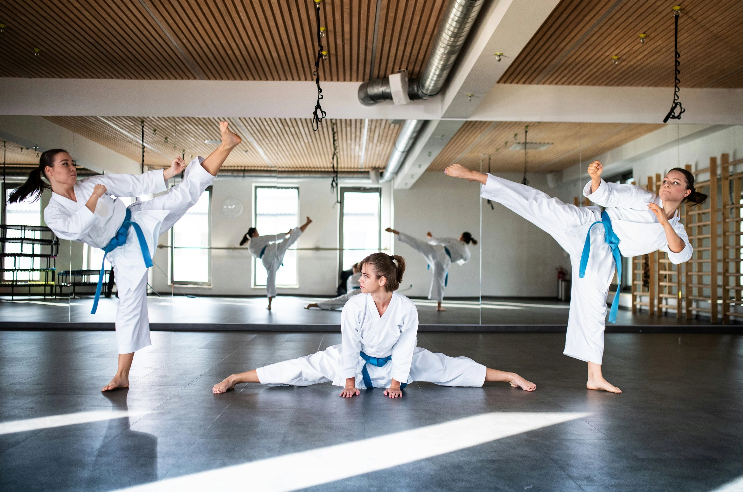 3 girls practicing at a martial arts dojo