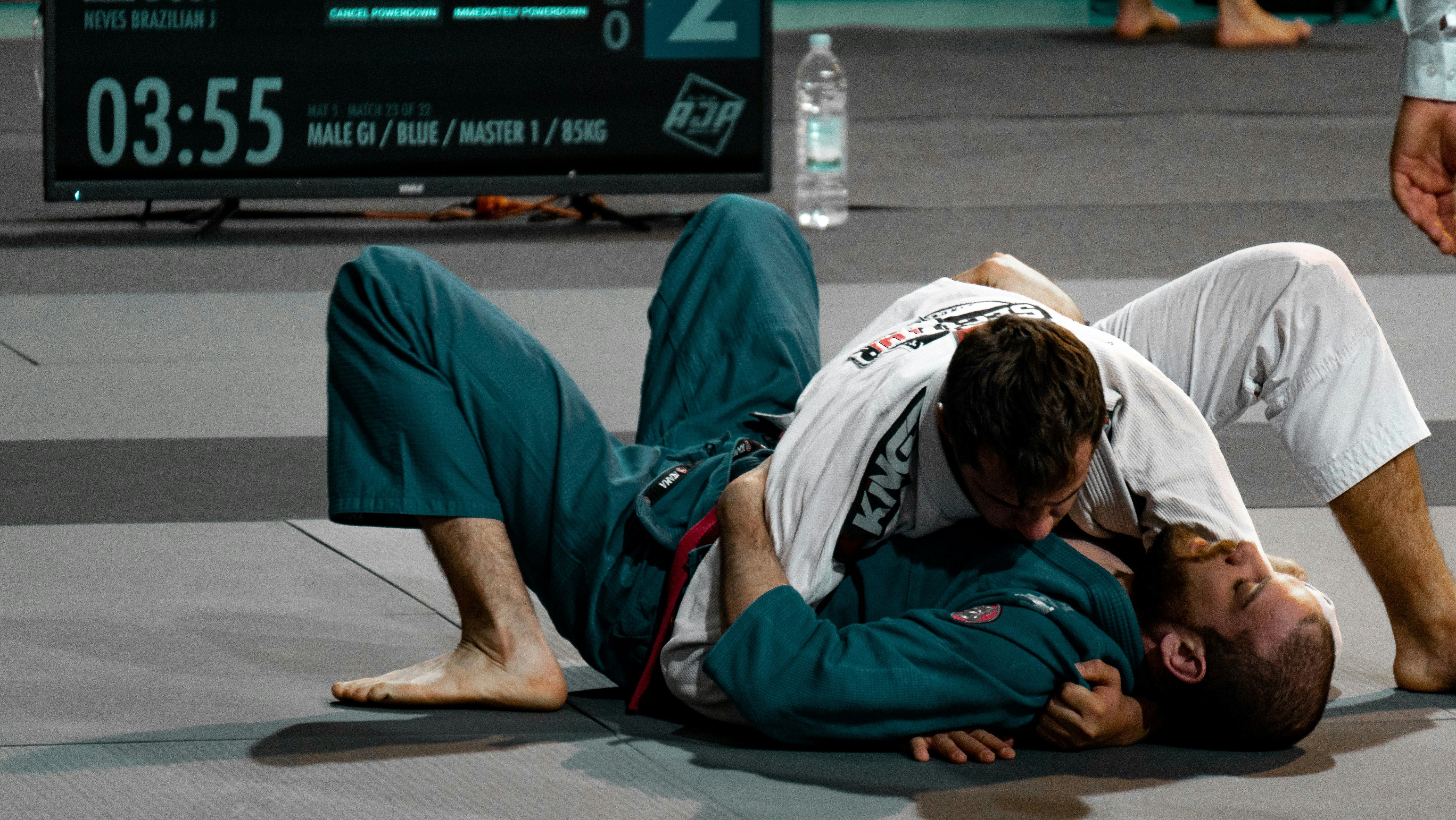 two people wrestling in martial arts competition