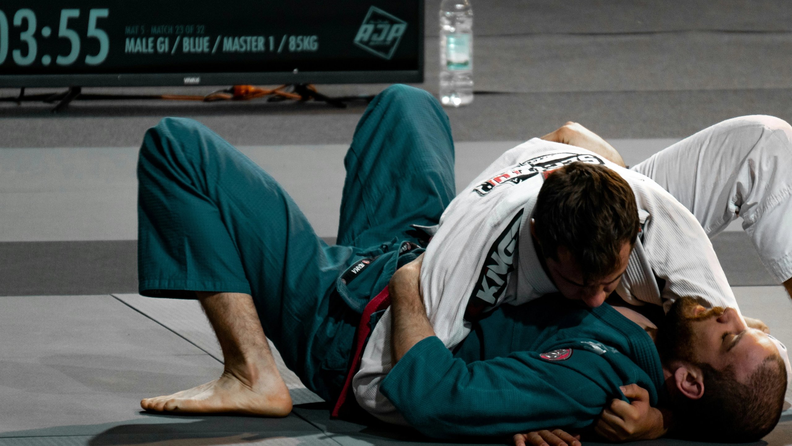 two people wrestling in martial arts competition