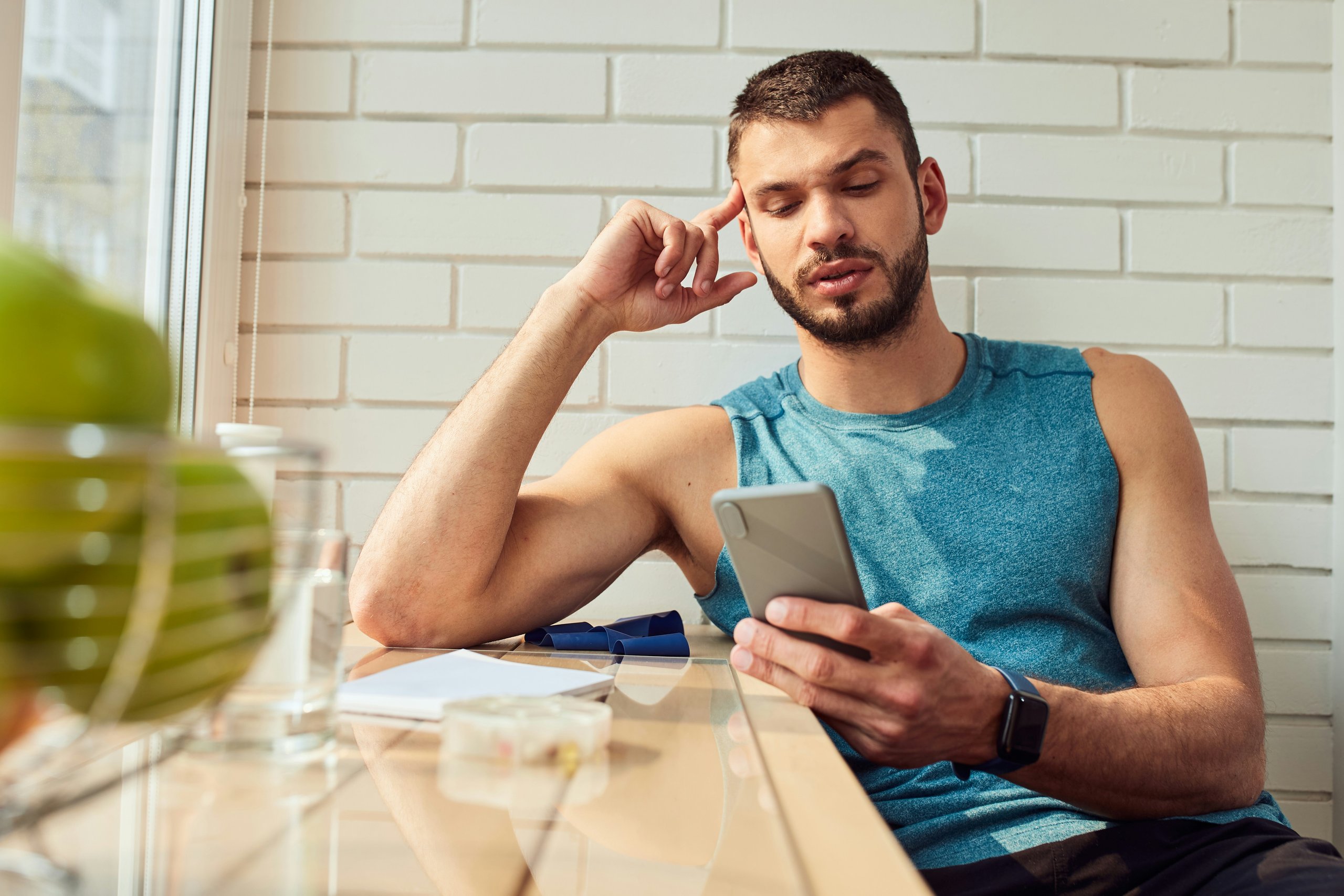 A 1club gym member checking out a push notification on their phone