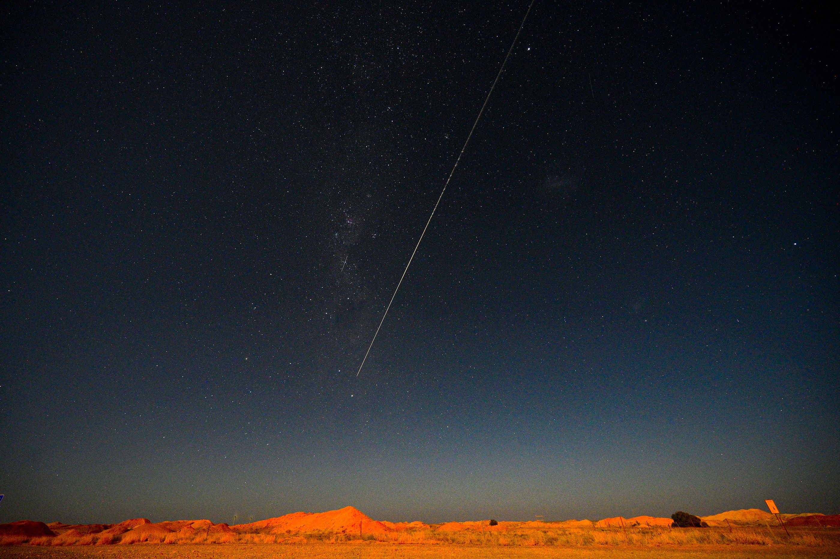 The Japan Aerospace Exploration Agency Hayabusa-2 probe’s sample is seen from Coober Pedy in South Australia dropping to earth after gathering material from an asteroid some 300 million kilometres from Earth, December 2020.