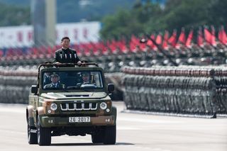 China’s President Xi Jinping inspects People’s Liberation Army soldiers