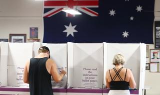 Australian voters cast their votes at an election polling booth