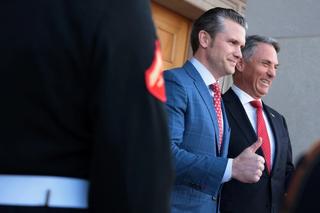 Two people meeting in front of an audience.