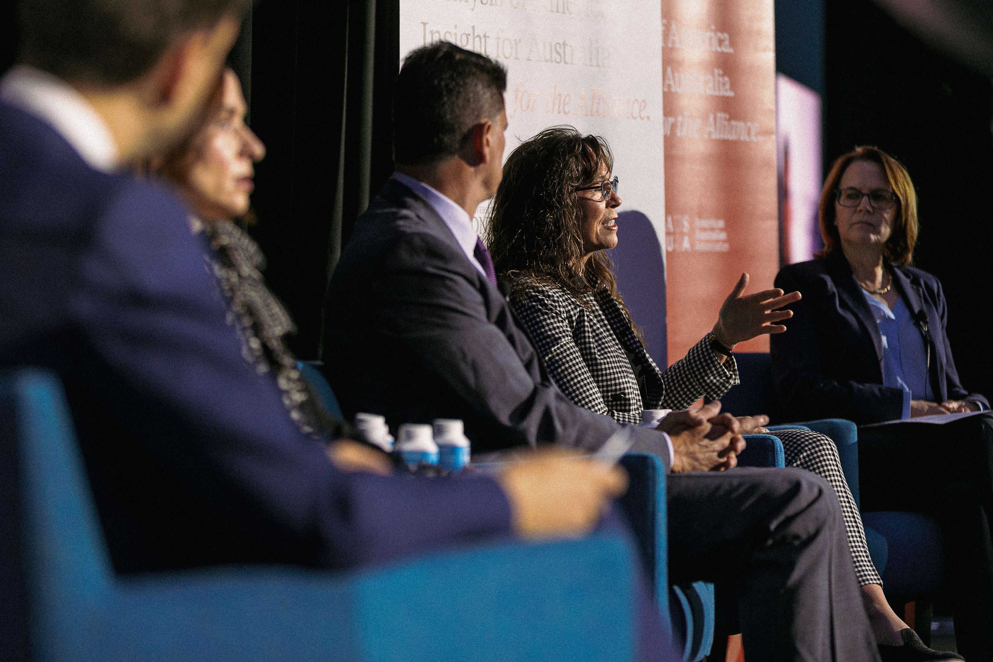 Dr Kori Schake speaking on stage with 4 fellow panellists.