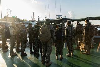 Australian, Indonesian and US military personnel taking part in Exercise Crocodile Response 2022 prepare to board  a landing craft in the Northern Territory, May 2022