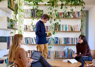 Three student interns reading and talking among themselves at the USSC's office.