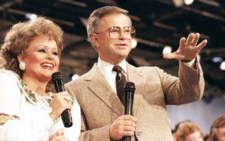 Tammy Faye Bakker and her then-husband, television evangelist Jim Bakker, talk to their TV audience at their PTL ministry near Fort Mill, SC, 20 August 1986