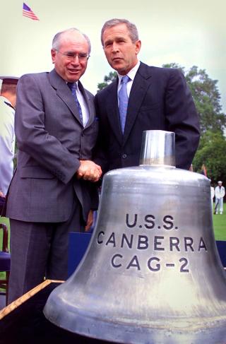 US President George W Bush presents Prime Minister Howard with the USS Canberra bell in Washington, 10 September 2001