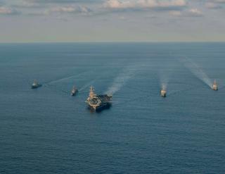 US Navy, Japan Maritime Self-Defense Force and Republic of Korea Navy ships sail together during a trilateral maritime exercise, 26 November 2023