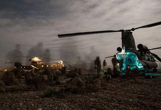 Army soldiers prepare to board CH-47 Chinook helicopters during a night-time operation in Uruzgan province, Afghanistan, June 2008 