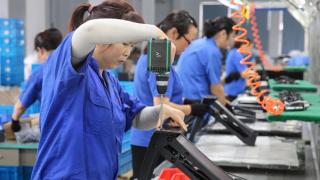 Workers produce desks for export at a factory in Nantong in China’s eastern Jiangsu province