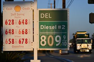 US-ECONOMY-DIESEL A garbage truck drives past gas prices above $6 a gallon and diesel prices above $8 a gallon as they are displayed outside of a Shell gas station in Carson, California on September 22, 2026. On September 22, US President Donald Trump expressed support for a diesel export ban, with fuel prices having surged on the back of the Middle East war.