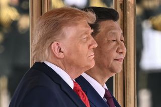 US President Donald Trump (L) and China's President Xi Jinping stand for their countries' national anthems during a welcome ceremony at the Great Hall of the People in Beijing on May 14, 2026.