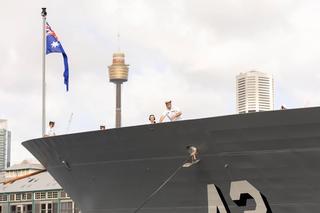 Ship’s company line the upper decks as HMAS Sydney returns to Fleet Base East following a successful regional presence deployment.