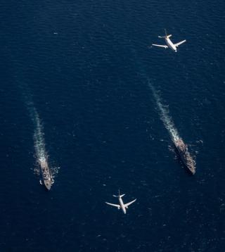 Indonesian Navy ship KRI Krans Kaisiepo, Royal Australian Navy ship HMAS Parramatta, a Royal Australian Air Force Boeing P-8A Poseidon aircraft and an Indonesian Air Force Boeing 737-2X9 Surveiller conduct a cooperative activity during a regional presence deployment, May 2022 