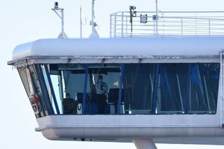 Crew members aboard the Diamond Princess cruise ship are seen at its wheelhouse