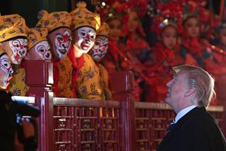 President Donald Trump talks to opera performers at the Forbidden City in Beijing, November 2017