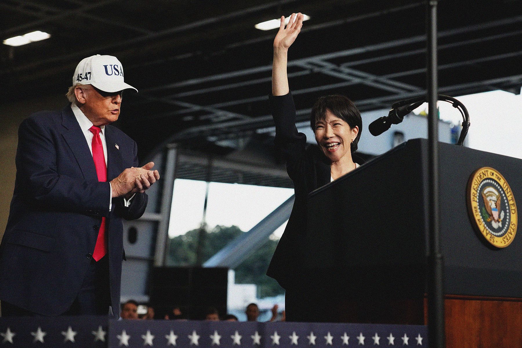 U.S. President Donald Trump applauds as Japanese Prime Minister Sanae Takaichi speaks to troops aboard USS George Washington at Fleet Activities Yokosuka on October 28, 2025 in Yokosuka, Japan. Trump is visiting Japan, fresh off an appearance at the ASEAN summit in Malaysia, and will next travel to South Korea for the APEC meetings. 