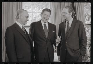 Washington: President Ronald Reagan meets Representatives Delbert Latta, (L), R-Ohio, and Phil Gramm, D-Texas, at the White House, May 7th. Gramm and Latta formulated a bipartisan budget bill which reflected Reagan's conservative philosophy, and succeeded in winning the support of all 190 Republican members of the house, as well as the votes of 63 Democrats to win passage of the administration-backed plan. The budget calls for federal spending of $689 billion in the next fiscal year and envisages a projected deficit of $31 billion.
