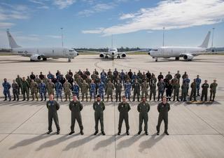 Crew and maintenance personnel from the Indian Navy P-8I and US Navy and RAAF P-8A aircraft gather for Exercise Malabar 2023 at RAAF Base Amberley.