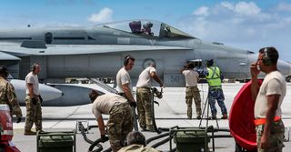 Maintainers from 77 Squadron and USAF refuel a RAAF F/A-18A Hornet during Exercise Cope North 2018 at Andersen Air Force Base, Guam