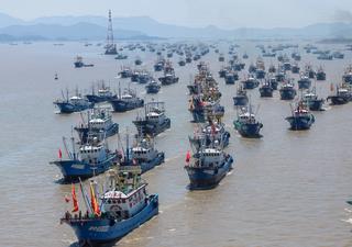 Chinese fishing boats head out to sea from Zhoushan in Zhejiang Province, China