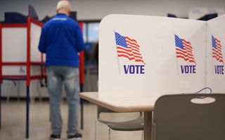 A person fills their ballot during the first day of early voting for the midterm elections in Minneapolis, Minnesota, on October 16, 2026