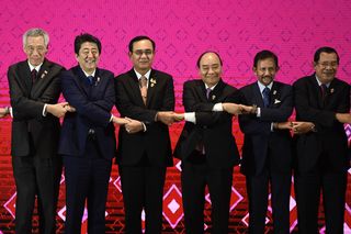 Singapore's Prime Minister Lee Hsien Loong, Japan's Prime Minister Shinzo Abe, Thailand's Prime Minister Prayut Chan-O-Cha, Vietnam's Prime Minister Nguyen Xuan Phuc, Brunei's Sultan Hassanal Bolkiah and Cambodia's Prime Minister Hun Sen pose for a group photo during the ASEAN Summit in Bangkok, November 2019