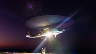 Able Seaman Aviation Support sailors Bailey Steenbuck and Max Newman conduct a high-line transfer with HMAS Canberra's embarked MH-60R aircraft during Indo-Pacific Endeavour 2023