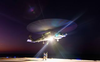 Able Seaman Aviation Support sailors Bailey Steenbuck and Max Newman conduct a high-line transfer with HMAS Canberra's embarked MH-60R aircraft during Indo-Pacific Endeavour 2023