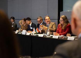 People discussing at a roundtable dialogue event