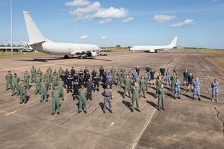 Royal Australian Air Force and Indian Navy aircrews and maintenance crews from the Indian Navy P-8I Neptune (left) and RAAF P-8A Poseidon aircraft at RAAF Base Darwin April 2022.
