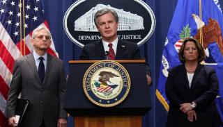 US Attorney General Merrick Garland, FBI Director Christopher Wray and Deputy Attorney General Lisa Monaco announce that the Department of Justice has charged 13 people for alleged efforts to unlawfully exert influence in the United States for the benefit of the government of China, Washington DC, 24 October 2022