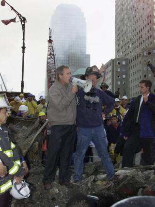 President George W Bush talks to rescue workers at the World Trade Center site, 14 September 2001