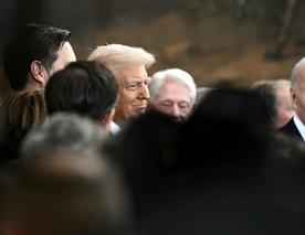 US President Donald J. Trump surrounded by people at his second inauguration.