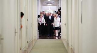 Prime Minister Tony Abbott and supporters walking to the party room to vote on a motion to spill the leadership