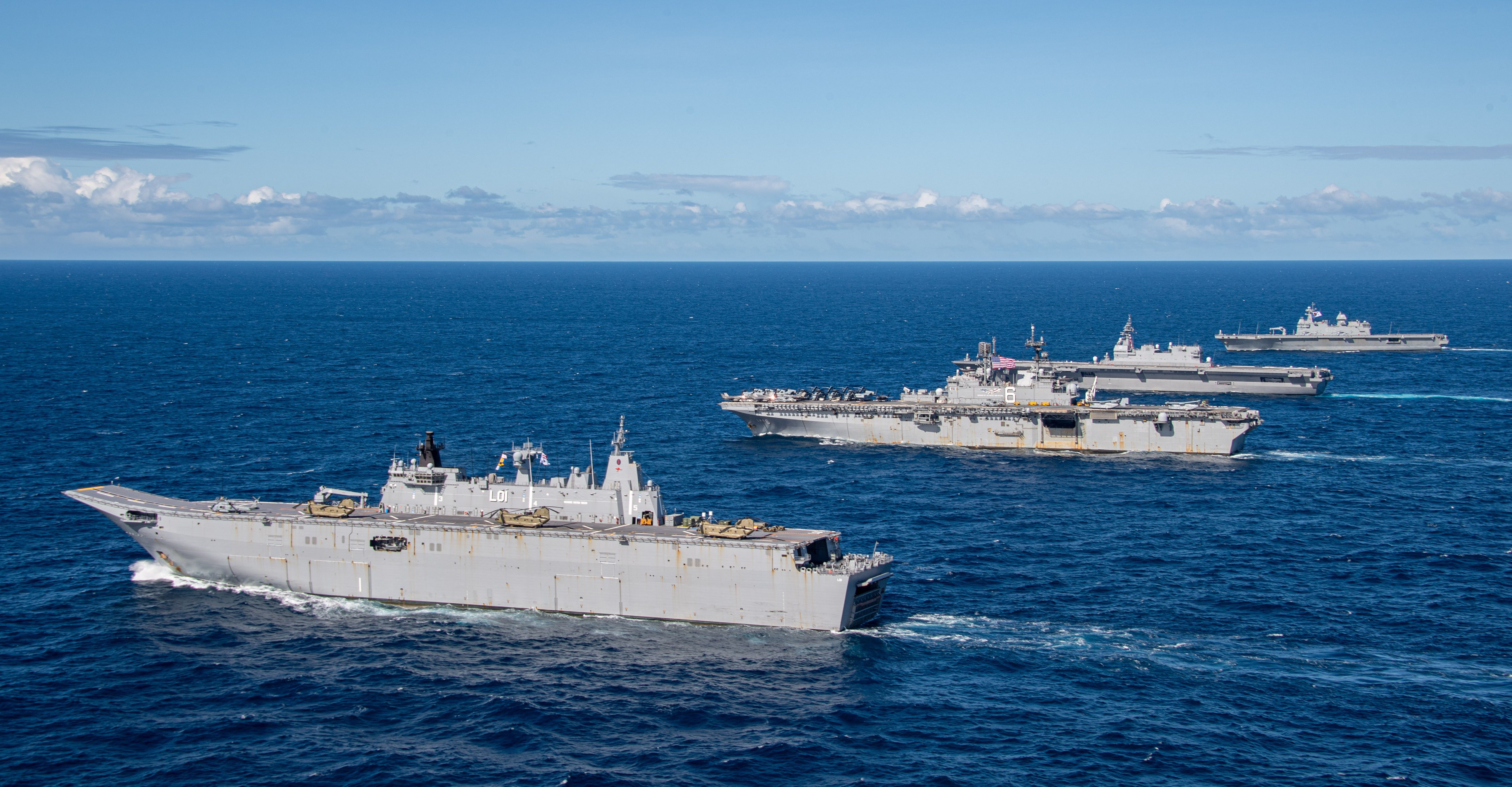 From front) Royal Australian Navy Canberra-class landing helicopter dock ship HMAS Adelaide (L01), United States Navy Amphibious assault carrier USS America (LHA 6), Japan Maritime Self-Defense Force helicopter destroyer JS Izumo (DDH 183), and Republic of Korea Navy amphibious assault ship ROKS Marado (LPH 6112), sail in formation during Exercise Talisman Sabre 2023