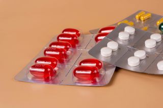 Pill packs on a pastel background.