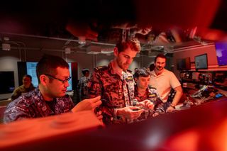 Personnel from the Royal Australian Navy and Japan Maritime Self Defence Force inspect hardware components during Exercise Blue Spectrum, Fleet Cyber Unit, Sydney, May 2024