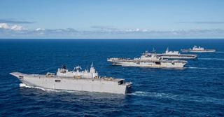 (From front) Royal Australian Navy Canberra-class landing helicopter dock ship HMAS Adelaide (L01), US Navy Amphibious assault carrier USS America (LHA 6), Japan Maritime Self-Defense Force helicopter destroyer JS Izumo (DDH 183), and Republic of Korea Navy amphibious assault ship ROKS Marado (LPH 6112) sail in formation during Exercise Talisman Sabre 2023.