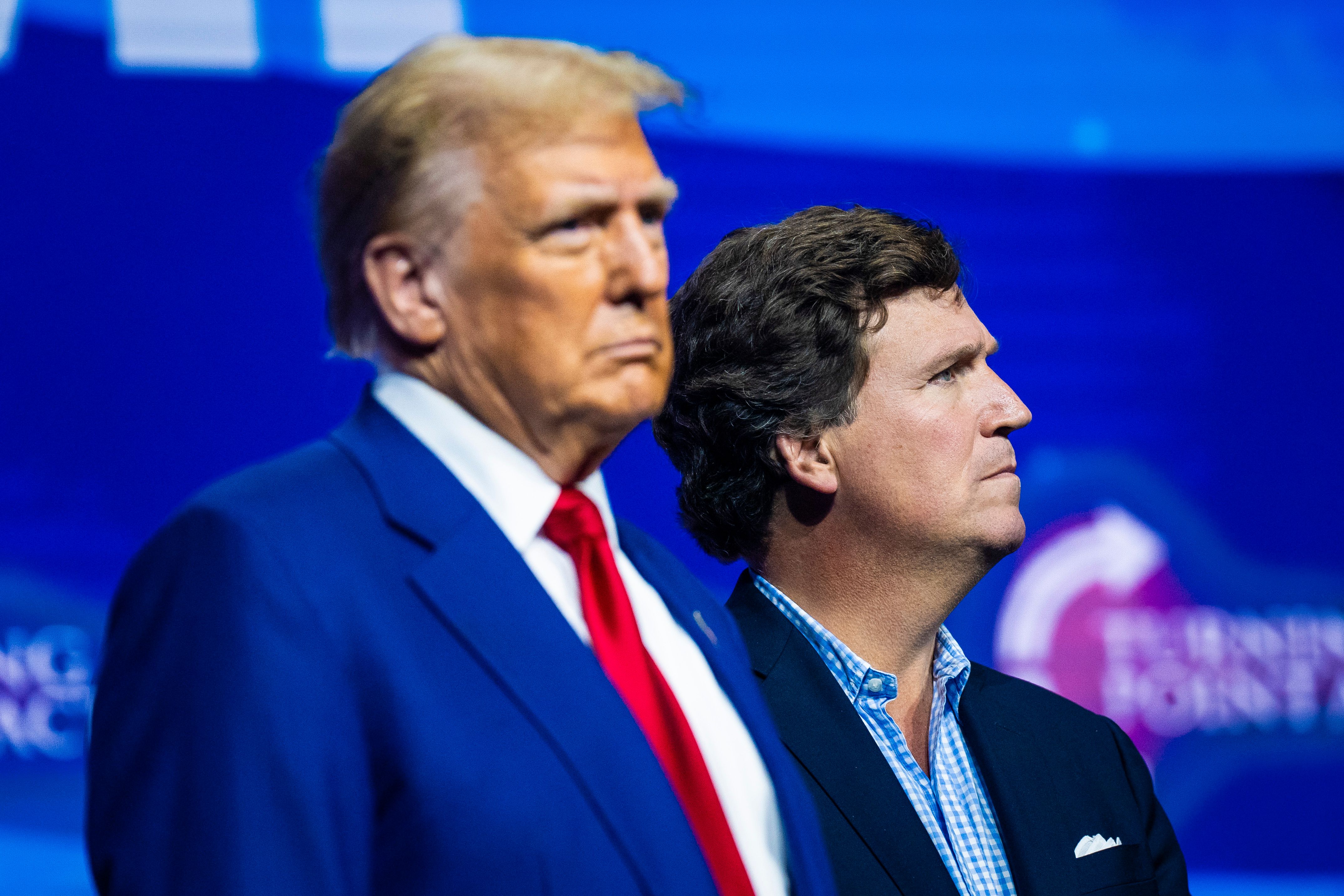 Republican presidential nominee former President Donald Trump and Tucker Carlson speak at a Turning Point Action Rally in Duluth, GA on Wednesday, Oct. 23, 2024.