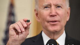 President Joe Biden holds a microchip as he speaks before signing an executive order on securing critical supply chains, Washington, DC, 24 February 2021