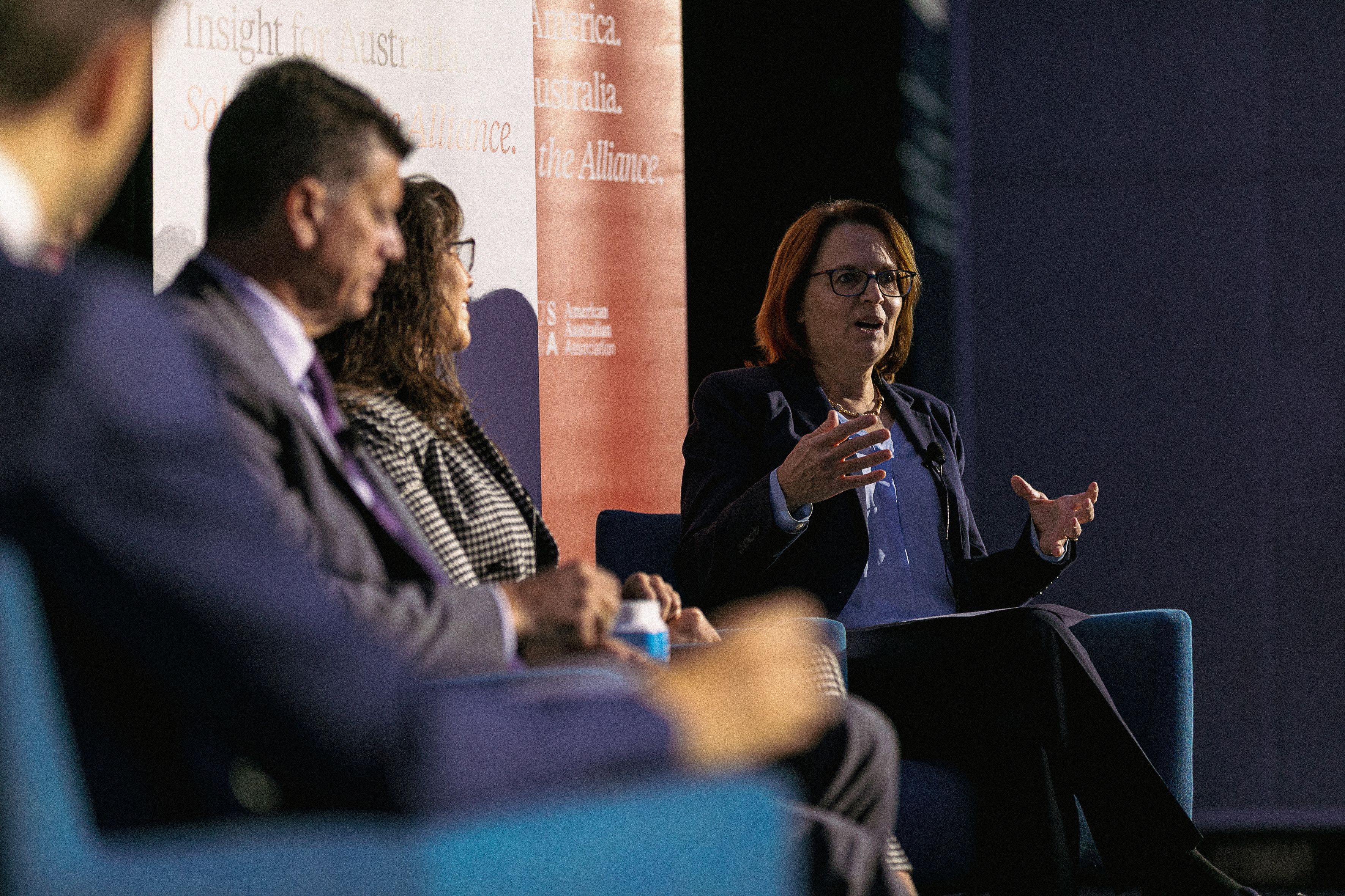 Lisa Curtis speaking on the panel on stage.