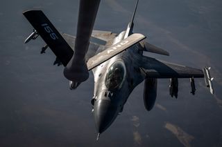 A U.S. Air Force F-16 Fighting Falcon aircraft approaches a KC-135 Stratotanker aircraft to refuel in the U.S. Central Command area of responsibility July 22, 2026.