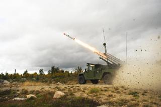 The NASAMS High Mobility Launcher on a HMMWV, firing an AMRAAM missile.