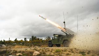 The NASAMS High Mobility Launcher on a HMMWV, firing an AMRAAM missile.