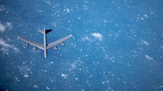A B-52 flies below a KC-135 tanker from the 100th Air Refueling Wing, March 2019 