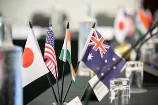 Flags of the Quad nations on a table